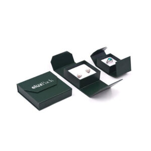 Dark green personalized jewelry boxes with a folding flap design, containing elegant jewelry pieces, including rings and earrings. These boxes provide a premium look for presenting and protecting fine jewelry.