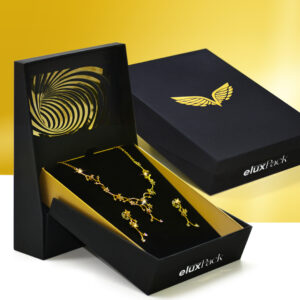 A luxury black and gold jewelery boxes with a stand-up display, showcasing a beautiful gold necklace and matching earrings. The box features elegant wing and spiral designs, perfect for high-end jewelry presentation.