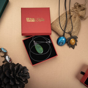 Elegant red and green custom jewelry box with accessories.